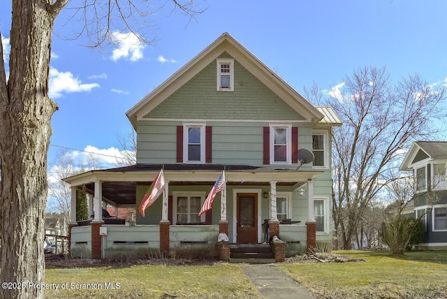 view of front of house with a front yard and covered porch