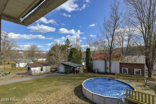 pool with an outbuilding and a lawn