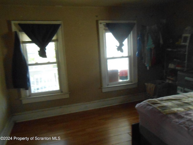 bedroom featuring hardwood / wood-style flooring and multiple windows