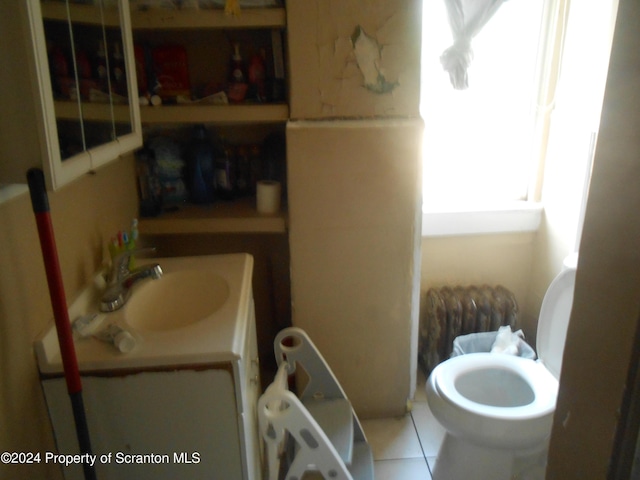 bathroom with tile patterned flooring, vanity, and toilet