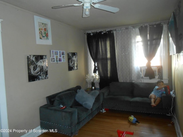 living room with wood-type flooring, ceiling fan, and cooling unit