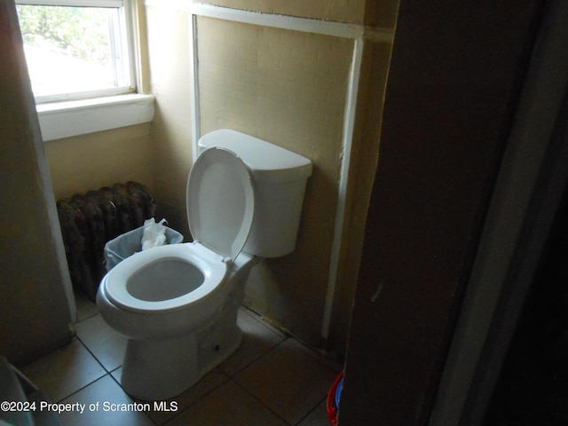 bathroom featuring toilet and tile patterned floors