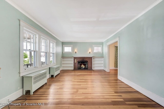 908 Prescott Ave, Scranton, PA 18510 - unfurnished living room with radiator, hardwood / wood-style floors, ornamental molding, and a fireplace