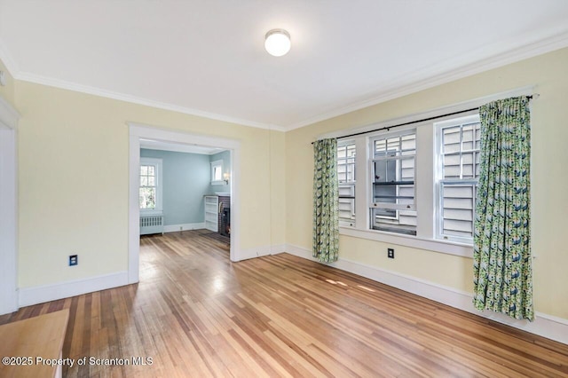 908 Prescott Ave, Scranton, PA 18510 - empty room with radiator heating unit, ornamental molding, and wood finished floors