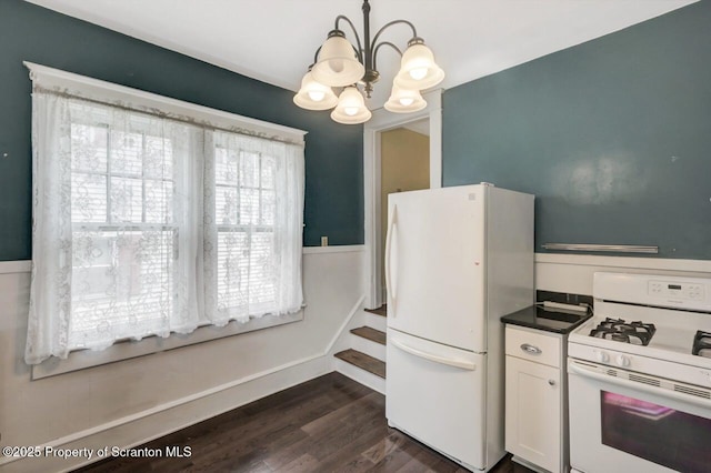 908 Prescott Ave, Scranton, PA 18510 - kitchen with white appliances, a chandelier, dark wood-type flooring, white cabinets, and dark countertops