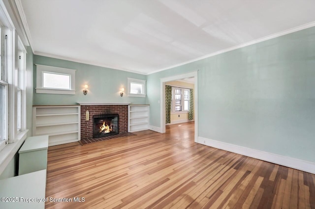 908 Prescott Ave, Scranton, PA 18510 - unfurnished living room with wood-type flooring, a brick fireplace, and crown molding