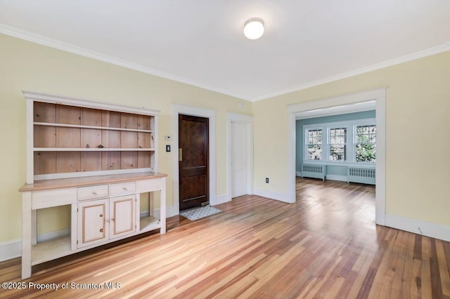 908 Prescott Ave, Scranton, PA 18510 - unfurnished living room with radiator, ornamental molding, and light wood-style flooring