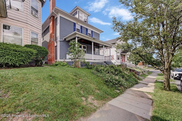 908 Prescott Ave, Scranton, PA 18510 - traditional style home with covered porch, a front lawn, stairs, and a chimney