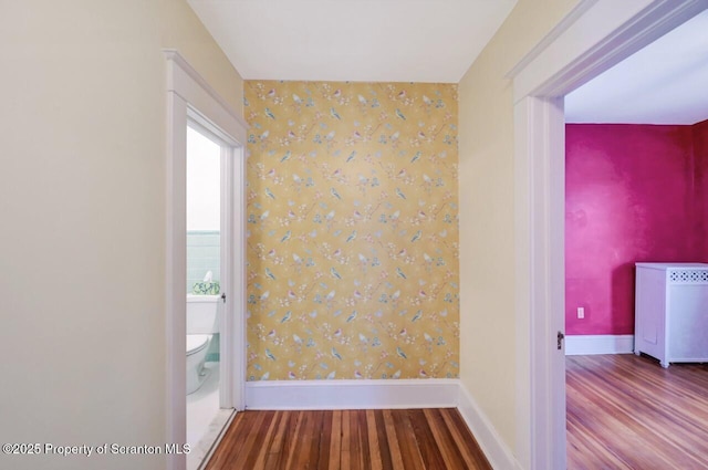 908 Prescott Ave, Scranton, PA 18510 - spare room with wood finished floors, wallpapered walls, radiator, and an accent wall