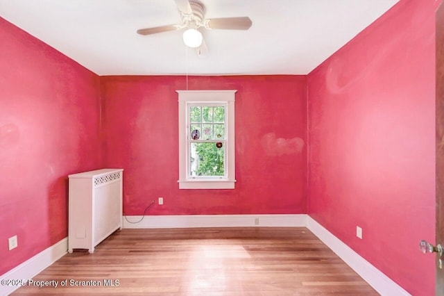 908 Prescott Ave, Scranton, PA 18510 - empty room with radiator heating unit, a ceiling fan, and wood finished floors