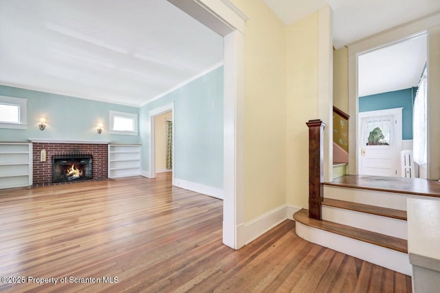 908 Prescott Ave, Scranton, PA 18510 - stairway featuring wood-type flooring, radiator, plenty of natural light, and a brick fireplace