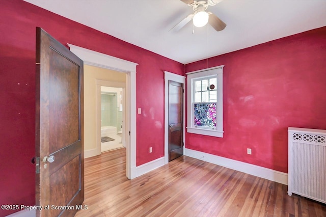 908 Prescott Ave, Scranton, PA 18510 - spare room featuring radiator, ceiling fan, and wood finished floors