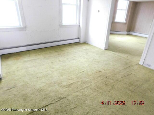spare room featuring plenty of natural light and carpet flooring