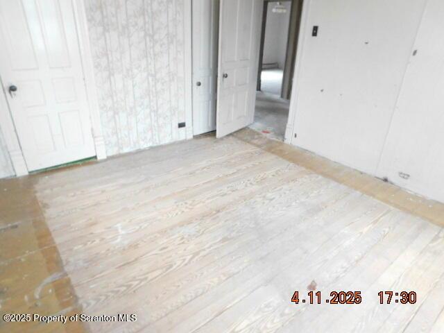unfurnished room with wood finished floors