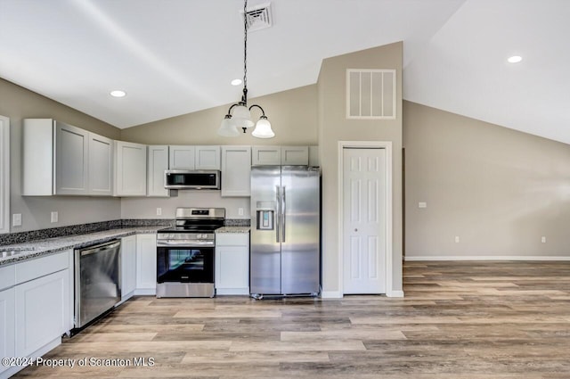 kitchen featuring visible vents, white cabinets, appliances with stainless steel finishes, light stone counters, and pendant lighting