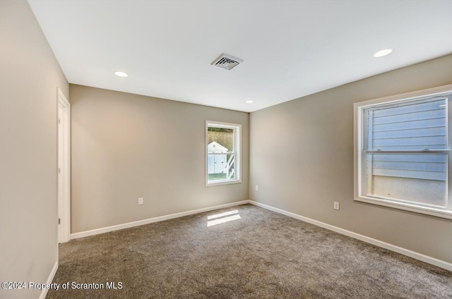 empty room with recessed lighting, carpet, visible vents, and baseboards