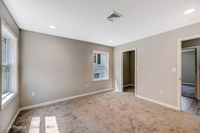 unfurnished bedroom with carpet, visible vents, baseboards, and recessed lighting