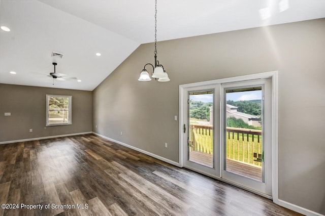 interior space featuring lofted ceiling, dark wood-style flooring, visible vents, and baseboards