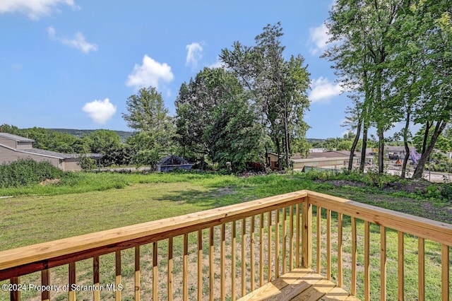 wooden deck featuring a yard