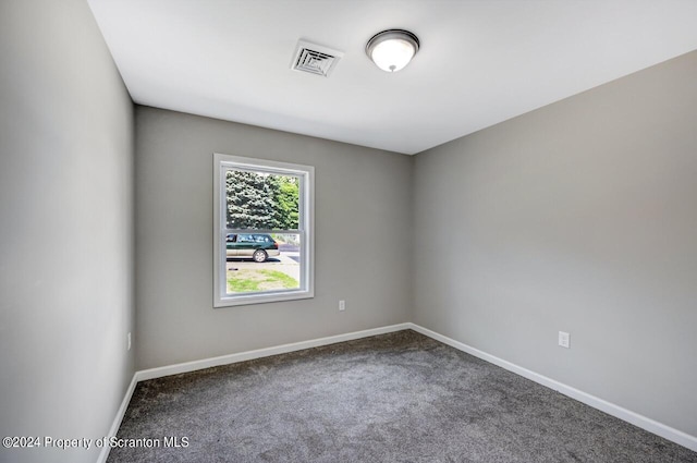 empty room featuring baseboards, visible vents, and carpet flooring