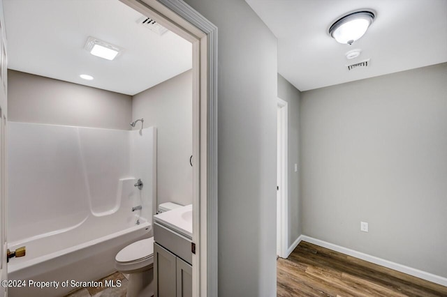 bathroom with visible vents, toilet, tub / shower combination, vanity, and wood finished floors