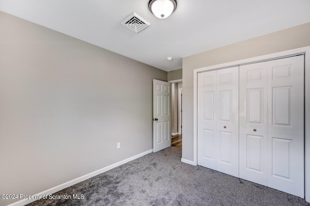 unfurnished bedroom with baseboards, a closet, visible vents, and light colored carpet