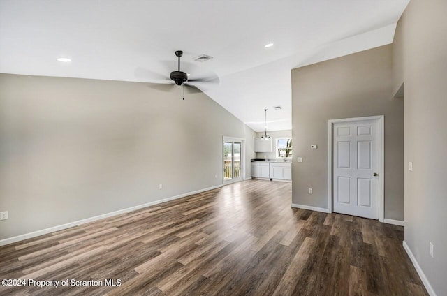 unfurnished living room with dark wood-type flooring, visible vents, baseboards, and a ceiling fan