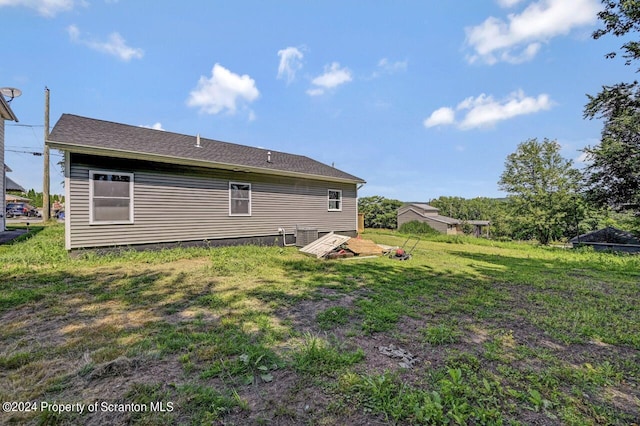 back of house with a lawn