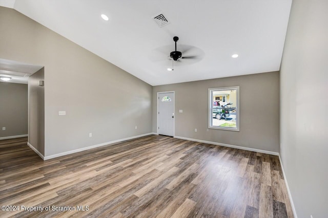 interior space with lofted ceiling, ceiling fan, visible vents, and wood finished floors