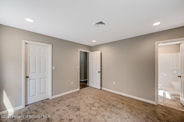 unfurnished bedroom with carpet, recessed lighting, visible vents, ensuite bathroom, and baseboards