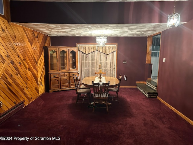 carpeted dining area with wooden walls and an inviting chandelier