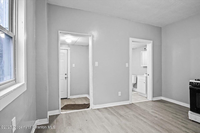 interior space with baseboards and wood finished floors