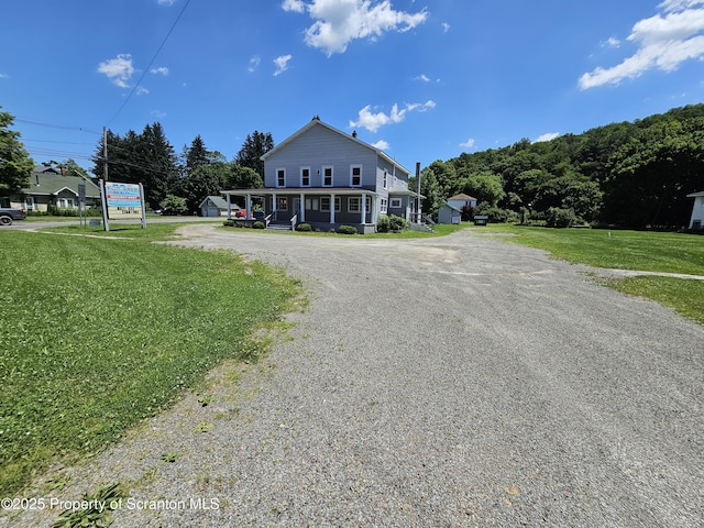 464 Main St, New Milford, PA 18834 - view of front of home with gravel driveway, a front lawn, and covered porch