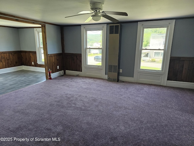 464 Main St, New Milford, PA 18834 - carpeted empty room with a wainscoted wall, healthy amount of natural light, and a ceiling fan