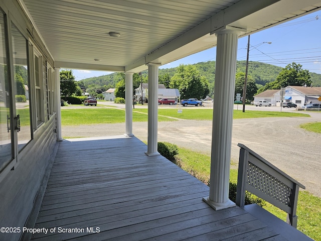 464 Main St, New Milford, PA 18834 - wooden porch with a mountain view and a yard
