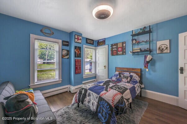 523 Hudson St, Forest City, PA 18421 - bedroom with wood finished floors and a baseboard radiator