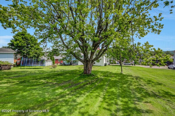523 Hudson St, Forest City, PA 18421 - view of green lawn featuring a trampoline
