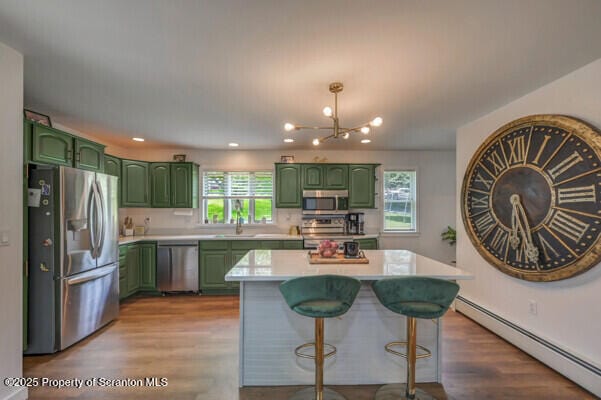 523 Hudson St, Forest City, PA 18421 - kitchen with appliances with stainless steel finishes, green cabinetry, a baseboard heating unit, and recessed lighting
