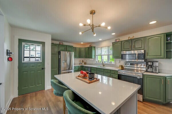523 Hudson St, Forest City, PA 18421 - kitchen featuring green cabinets, appliances with stainless steel finishes, a chandelier, light countertops, and recessed lighting