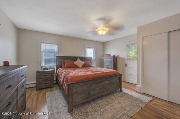 523 Hudson St, Forest City, PA 18421 - bedroom featuring wood finished floors, a baseboard heating unit, and ceiling fan
