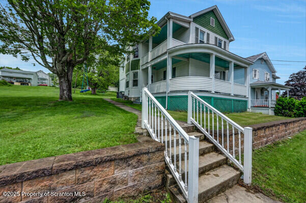 523 Hudson St, Forest City, PA 18421 - view of front of house featuring covered porch and a front lawn