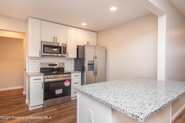 kitchen featuring white cabinets, light stone countertops, and appliances with stainless steel finishes