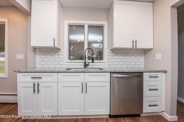 kitchen with dishwasher, backsplash, sink, light stone countertops, and white cabinetry