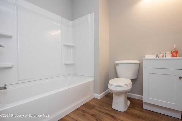 full bathroom featuring hardwood / wood-style floors, vanity,  shower combination, and toilet