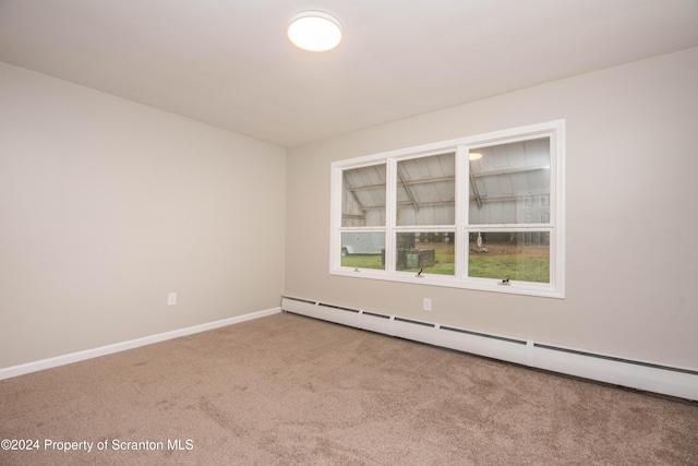 carpeted spare room with baseboard heating