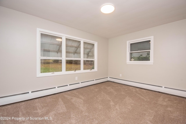 carpeted spare room with baseboard heating