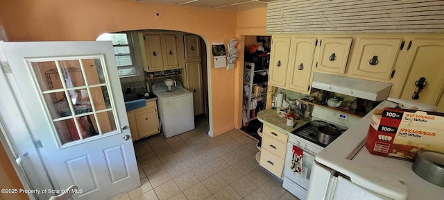 525 N Irving Ave, Scranton, PA 18510 - kitchen with washer / dryer, arched walkways, light tile patterned floors, under cabinet range hood, and light countertops