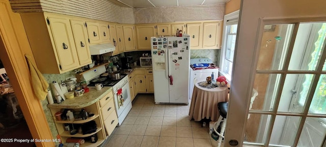 525 N Irving Ave, Scranton, PA 18510 - kitchen featuring white appliances, under cabinet range hood, light tile patterned floors, washer / dryer, and light countertops