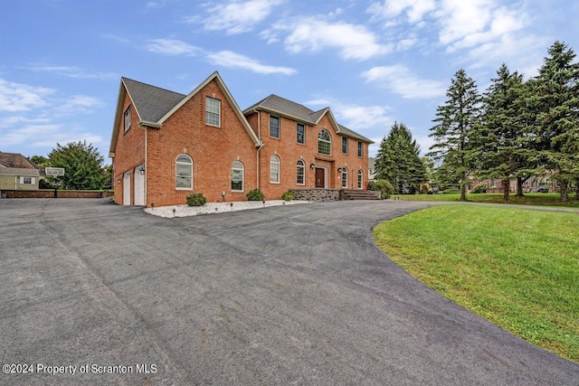 view of front of house with a front yard and a garage