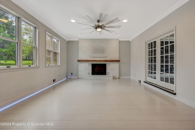 unfurnished living room featuring a fireplace, light wood-type flooring, ceiling fan, and ornamental molding